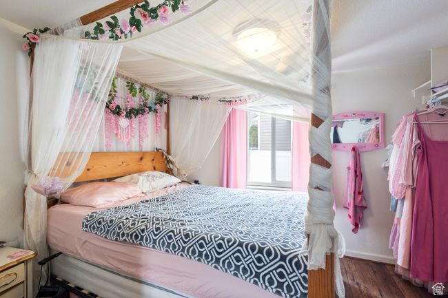 Bedroom featuring wood finished floors and baseboards | Image 10