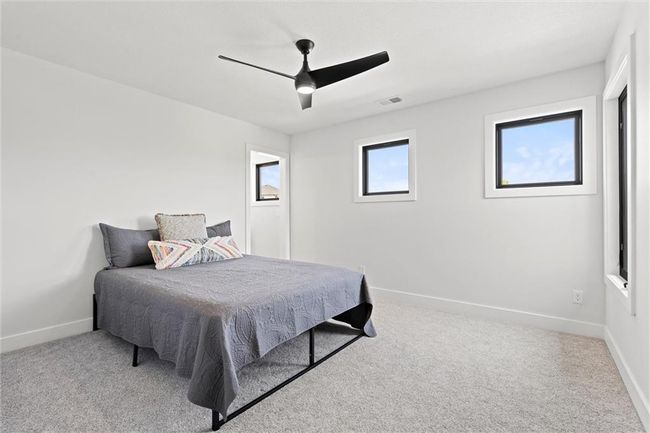 Carpeted bedroom with baseboards and a ceiling fan | Image 32
