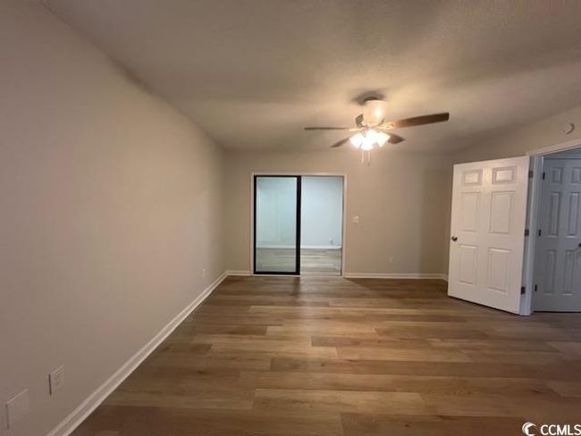 Empty room featuring baseboards, a ceiling fan, and wood finished floors | Image 8