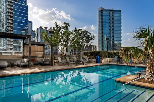Community pool featuring outdoor lounge area and a city view | Image 19