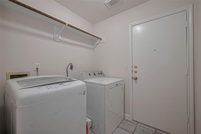 Laundry room conveniently located just off the garage for easy access and functionality.Laundry room conveniently located just off the garage for easy access and functionality. Dryer is included! | Image 14