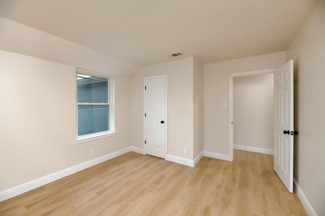 Unfurnished bedroom with light wood-style floors and baseboards | Image 17
