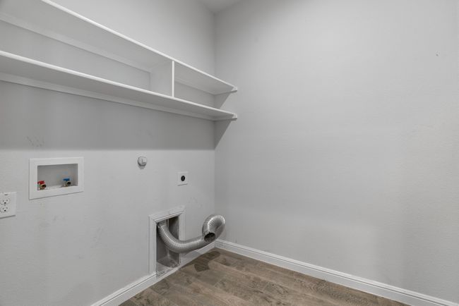 Washroom featuring hookup for a gas dryer, washer hookup, electric dryer hookup, laundry area, and dark wood-style flooring | Image 18