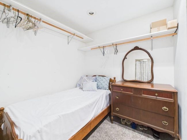 Walk-in closet off Primary Bathroom with carpet - currently being used as an extra sleeping area | Image 27