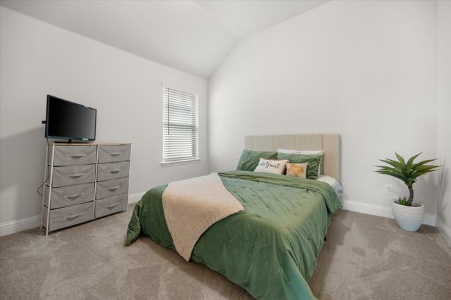 Carpeted bedroom featuring lofted ceiling and baseboards | Image 20