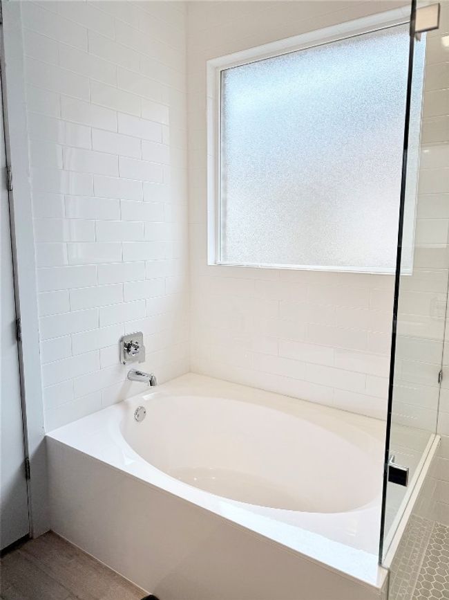 Bright and airy bathroom with a garden soaking tub and walk-in shower | Image 23