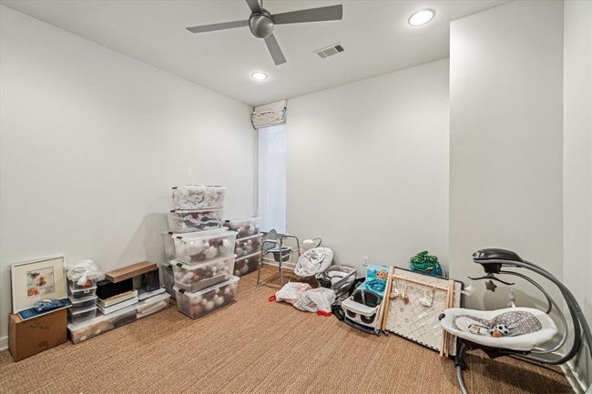 BEDROOM #3 (15 X 11) with the shared bath, includes grass cloth flooring, base molding, painted wall, corner vertical window with blackout shade, ceiling fan, recessed lighting, walk-in closet with hanging compartments and built-in shelving. | Image 34