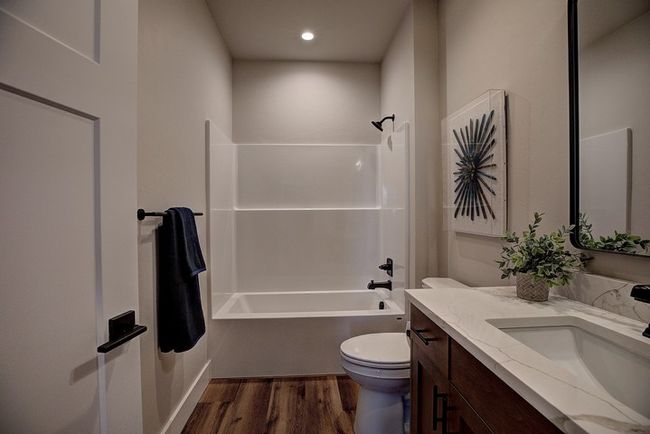 Full bathroom with bathtub / shower combination, vanity, and dark wood-style floors | Image 31