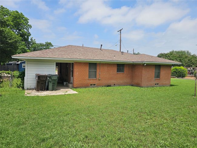 Back of property featuring crawl space, brick siding, and roof with shingles | Image 12