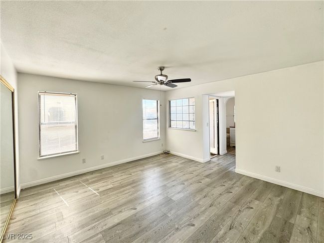 Primary room with wood finished floors, ceiling fan, and a textured ceiling | Image 13
