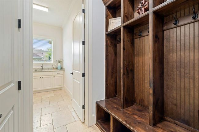 Built-in cubbies make it easy to store backpacks, coats, and shoes for a family on the go. Located between the garage entrance and the Laundry Room, this storage unit is very convenient. | Image 23