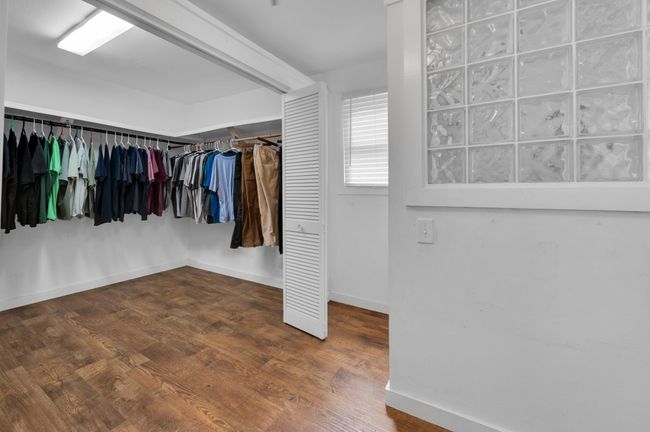 Walk in closet with wood finished floors | Image 18