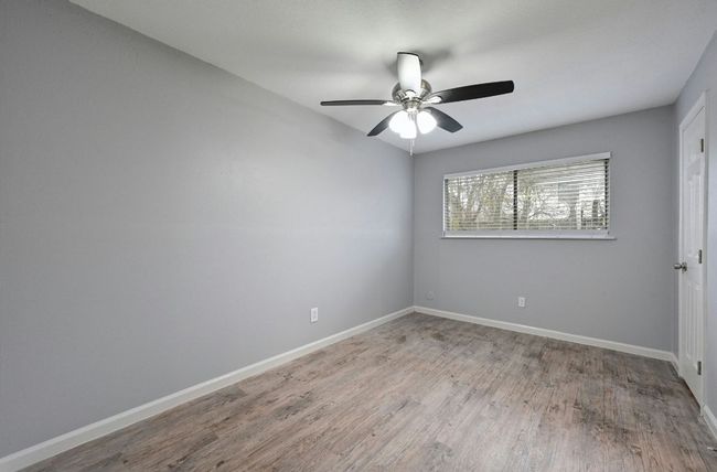 Spare room featuring light wood-style flooring and a ceiling fan | Image 16