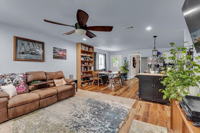 Living area with ceiling fan, light wood-style floors, and recessed lighting | Image 5