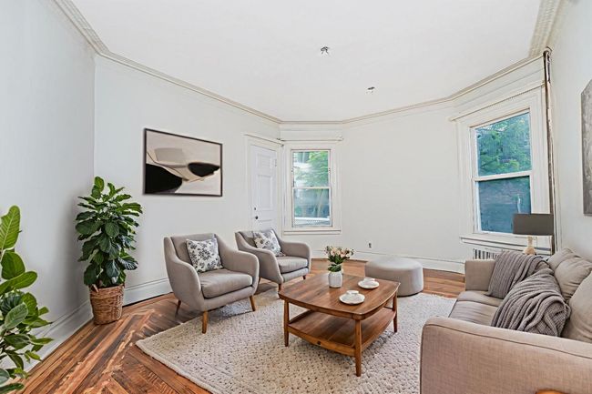 Living area with plenty of natural light and crown molding | Image 14
