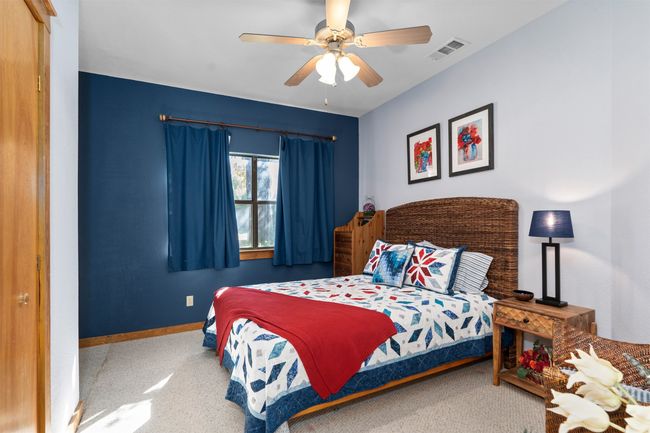 Bedroom featuring ceiling fan and carpet floors | Image 19