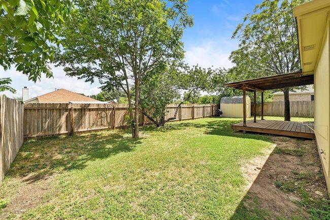 Fenced backyard featuring a shed and a wooden deck | Image 33