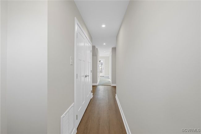 Corridor featuring baseboards, recessed lighting, dark wood-style floors, and visible vents | Image 11
