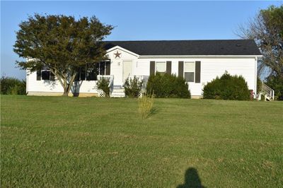 View of front facade with a front lawn | Image 1