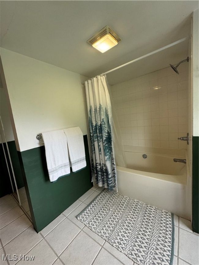 Full bathroom with tile patterned floors and shower / bath combo with shower curtain | Image 31