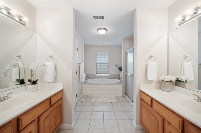 Owners en-suite with dual vanities, walk in shower, separate water closet and large tub. | Image 14