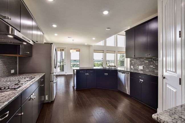 Kitchen with stainless steel appliances, ventilation hood, a peninsula, plenty of natural light, and recessed lighting | Image 10