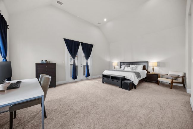 Bedroom featuring carpet floors, an office area, access to exterior, and high vaulted ceiling | Image 16