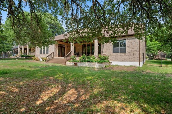 View of front of home featuring brick siding, fence private yard, and a front yard | Image 35