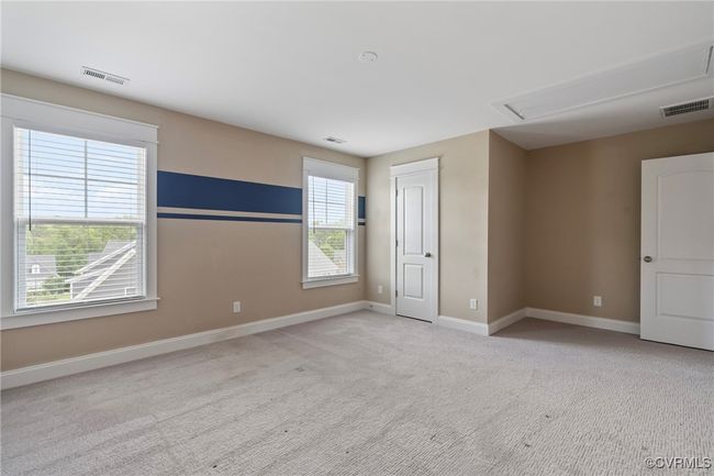 Unfurnished bedroom with attic access and carpet floors | Image 36