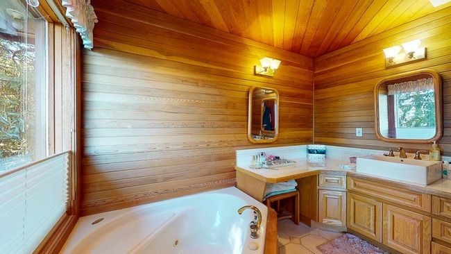 Full bathroom featuring vanity, a whirlpool tub, shower, and real cedar ceiling and walls | Image 29