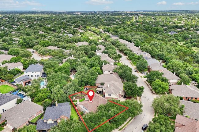 Situated on a spacious lot in a serene, tree-lined neighborhood. | Image 35