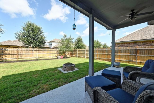 Large Fenced backyard with ceiling fan, an outdoor fire pit, and a patio area | Image 27
