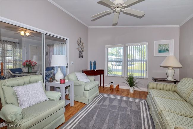Living room with hardwood / wood-style floors, crown molding, and vaulted ceiling | Image 21