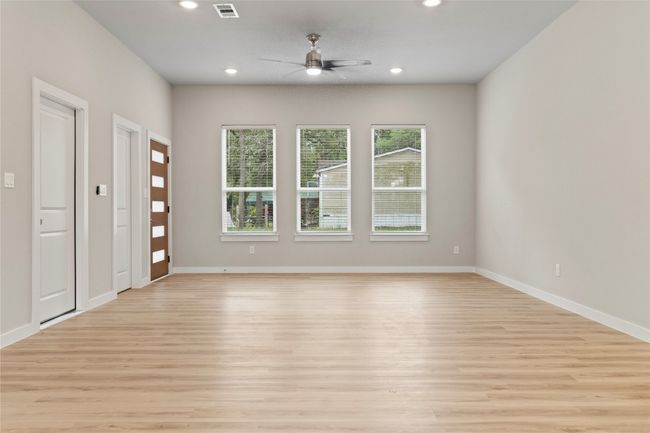 An inviting open floor plan, seamlessly connecting the living and dining areas, bathed in natural light—shown from a different angle. | Image 13