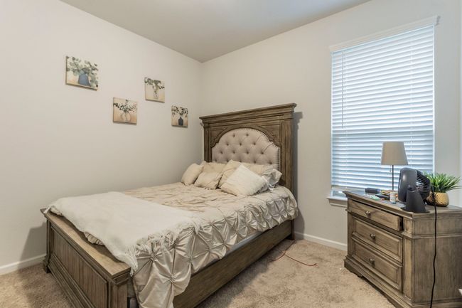 Bedroom featuring light colored carpet and baseboards | Image 12