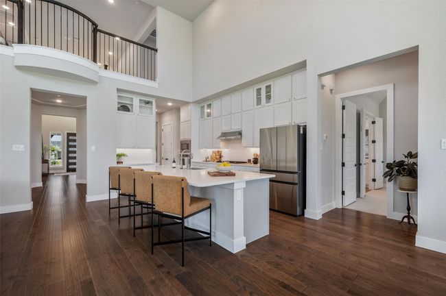 Large island with counter seating perfect for hanging out during dinner preparation or eating casual meal. | Image 8