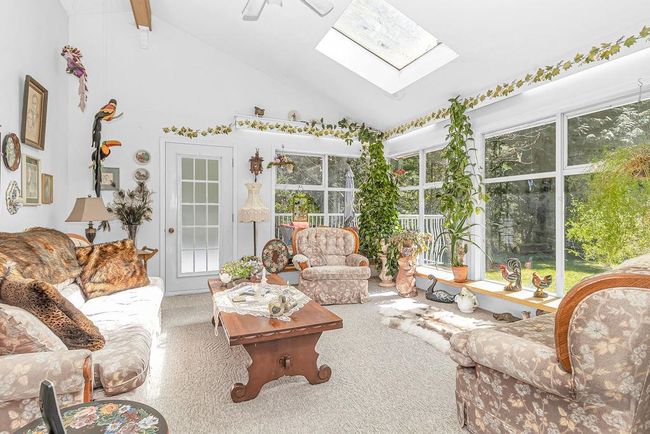 Sunroom / solarium with plenty of natural light and vaulted ceiling with skylight | Image 10