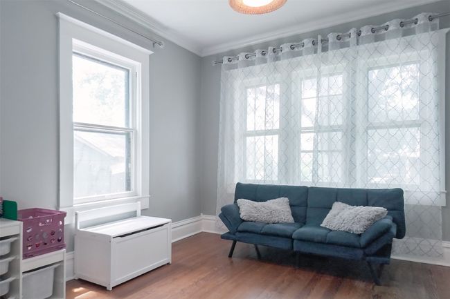 Living area with wood finished floors and ornamental molding | Image 8
