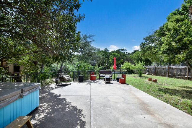 Fenced backyard with a patio area | Image 28