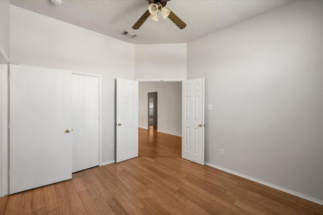 Bedroom or Flex room featuring wood finished floors and ceiling fan | Image 19