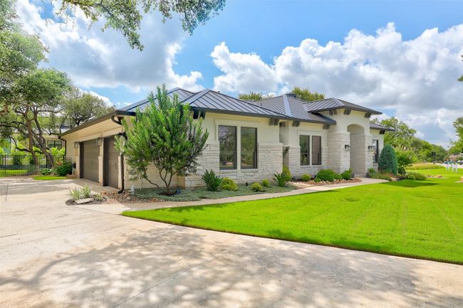 View of front of home with stone and a metal roof | Image 40