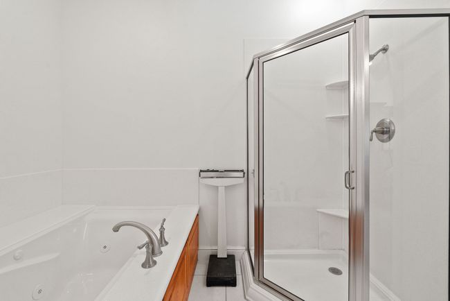 Jetted tub, step-in shower, tile flooring | Image 22