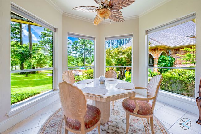Sunroom with ceiling fan and a healthy amount of sunlight | Image 23