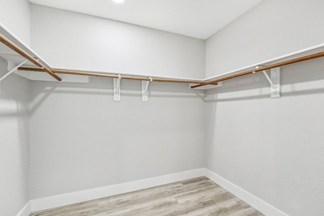 Spacious closet featuring light wood-style flooring | Image 25