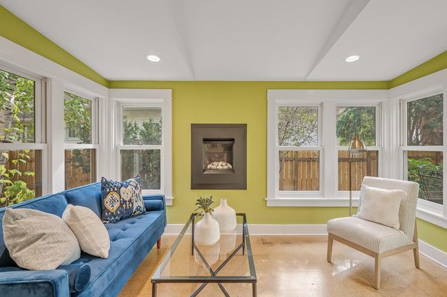 This sunroom has heated flooring and a gas fireplace. | Image 34