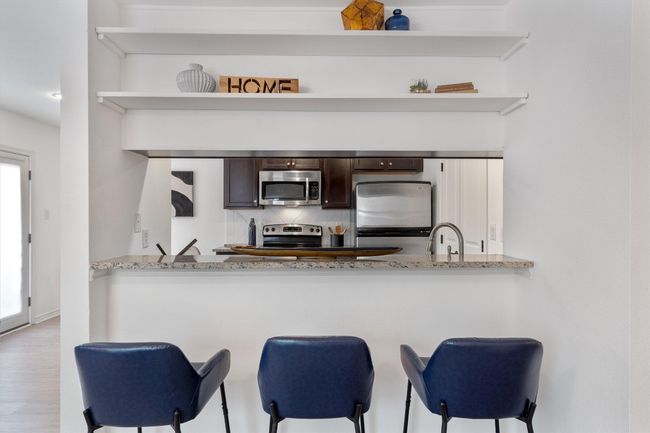 The breakfast bar provides a convenient spot for casual meals and drinks. | Image 10