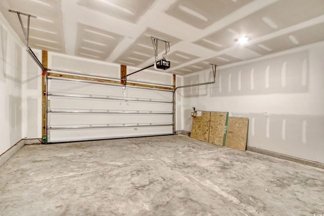 Garage with a garage door opener | Image 9