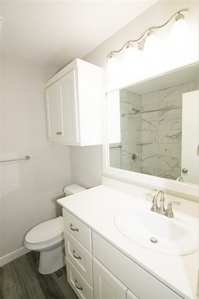 Full bath with vanity, tiled shower, and wood finished floors | Image 15
