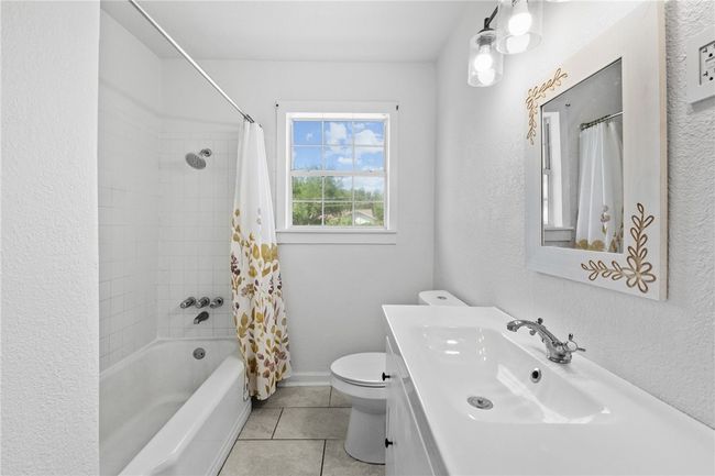 Hall bathroom with tile shower and porcelain tub | Image 8