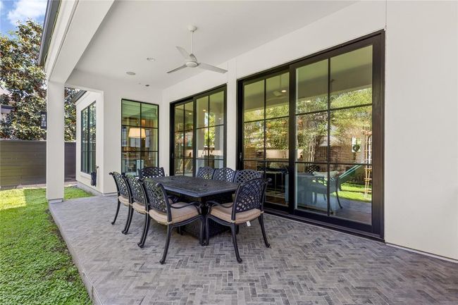 Herringbone brick patio w/ recessed lighting, sliding doors, ceiling fan. | Image 47